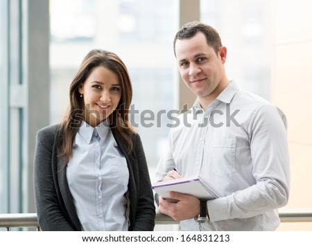 Two young people discussing business issues.