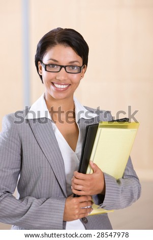Portrait of a smiling businesswoman holding folder
