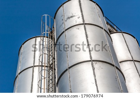 Old Steel industrial tanks with blue sky background.