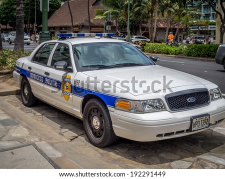 WAIKIKI, HAWAII - APRIL 25: Honolulu Police Department police car parked in Waikiki on April 25, 2014. The white and blue cruiser is parked on kalakaua Avenue.