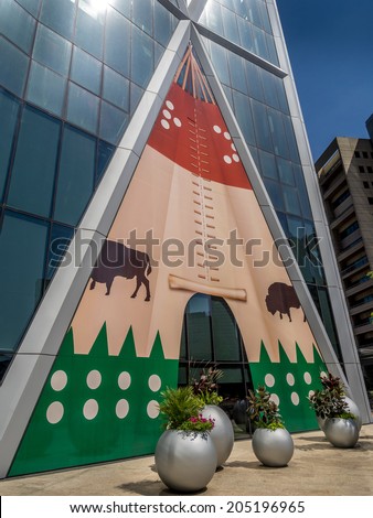 CALGARY, CANADA - JULY 13: The Bow Tower decorated for the Calgary Stampede on July 13, 2014 in Calgary, Alberta Canada. Here the exterior of the Bow is decorated with a Blackfoot Indian Tepee.
