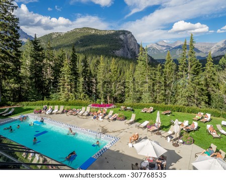 BANFF, CANADA - AUG 9, 2015: Outdoor pool at the Banff Springs Hotel on August 19, 2015 in the Canadian Rockies. The Banff Springs Hotel was built during the 9th century in Scottish Baronial style.