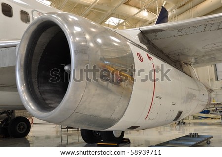 Jet aircraft engine on passenger jet in hangar of a school for training ground crews.