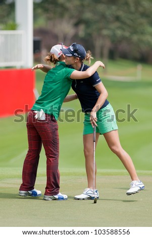 PATTAYA, THAILAND-FEBRUARY 16: Azahara Munoz of Spain (R) thanks another golfer after finish hole 18 on Day 1 of Honda LPGA 2012 on February 16 2012 at Siam Country Club Old Course in Pattaya Thailand