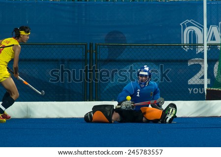 NANJING, CHINA-AUGUST 21: Germany Hockey Team goalie (blue) defends the goal against China Hockey Team (yellow) during Day 5 match of 2014 Youth Olympic Games on August 21, 2014 in Nanjing, China.
