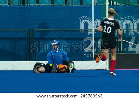 NANJING, CHINA-AUGUST 21: Germany Hockey Team goalie (blue) defends the goal against China Hockey Team during Day 5 match of 2014 Youth Olympic Games on August 21, 2014 in Nanjing, China.