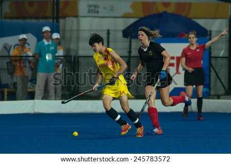 NANJING, CHINA-AUGUST 21: China Hockey Team (yellow) plays against Germany Hockey Team (black) during Day 5 match of 2014 Youth Olympic Games on August 21, 2014 in Nanjing, China.