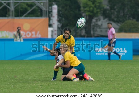 NANJING, CHINA-AUGUST 19: Australia Rugby Team (yellow) tackles USA Rugby Team (white) during semifinals match of 2014 Youth Olympic Games on August 19, 2014 in Nanjing, China. Australia wins 33-0.