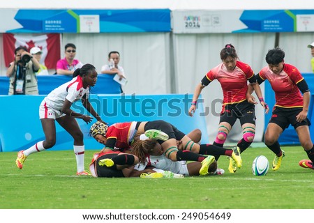 NANJING, CHINA-AUGUST 19: Canada Rugby Team (white) plays against China Rugby Team (red) during semifinals match of 2014 Youth Olympic Games on August 19, 2014 in Nanjing, China.
