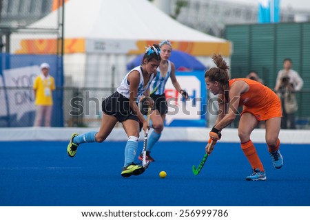 NANJING, CHINA-AUGUST 20: Argentina Hockey Team (white-blue) plays against Holland Hockey Team (orange) during Day 4 match of 2014 Youth Olympic Games on August 20, 2014 in Nanjing, China.