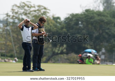 HUAHIN, THAILAND-FEBRUARY 12: Jerome Lando Casanova (L) of France waits for his turn to putt on Day 1 of 2015 True Thailand Classic, February 12, 2015 at Black Mountain Golf Club in Hua Hin, Thailand