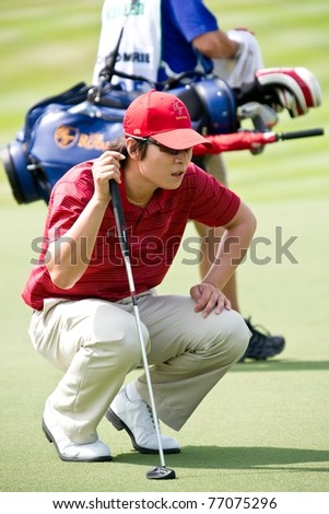 HUA HIN, THAILAND - JANUARY 7:  Kim Kyung-tae of Korea thinks of his next move on day 1 of The Royal Trophy tournament on January 7, 2011 at Black Mountain Golf Club in Hua Hin, Thailand