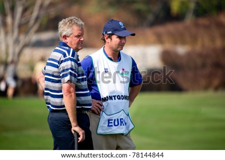 HUA HIN, THAILAND - JANUARY 8: Scottish golfer Colin Montgomerie waits for his turn to putt during Day 2 of The Royal Trophy at Black Mountain Golf Club on January 8, 2011 in Hua Hin, Thailand