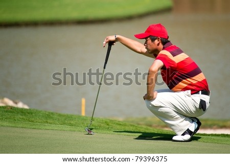 HUA HIN, THAILAND - JANUARY 9: Yuta Ikeda of Japan thinks of his next move on hole 9 during Day 3 of The Royal Trophy tournament on January 9, 2011 at Black Mountain Golf Club in Hua Hin, Thailand
