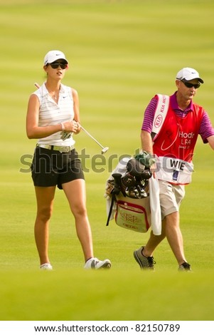 PATTAYA THAILAND - FEBRUARY 19: US golfer Michelle Wie walks towards hole 17 during day 3 of Honda LPGA Thailand 2011on February 19, 2011 at Siam Country Club Old Course in Pattaya, Thailand