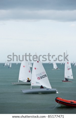 CHA-AM THAILAND - AUGUST 26: Unidentified sailboats get back shore during rain storm on Day 4 of the 2011 Hua Hin Regatta on August 26, 2011 at Dusit Thani Resort & Spa Hua Hin in Cha-Am, Thailand