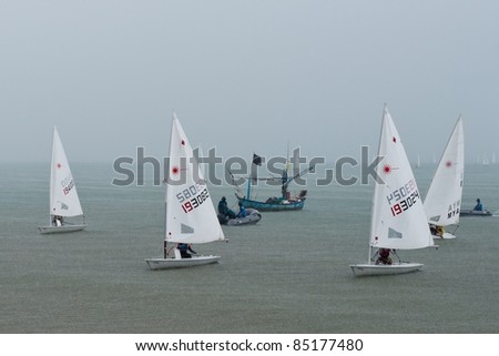 CHA-AM THAILAND - AUGUST 26: Unidentified sailboats get back shore during rain storm on Day 4 of the 2011 Hua Hin Regatta on August 26, 2011 at Dusit Thani Resort & Spa Hua Hin in Cha-Am, Thailand