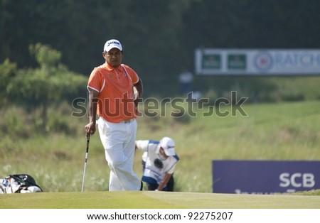CHONBURI, THAILAND - DECEMBER 15: Chapchai Nirat of Thailand waits for a turn to putt during Day 1 of Thailand Golf Championship on December 15, 2011 at Amata Spring Country Club in Chonburi, Thailand