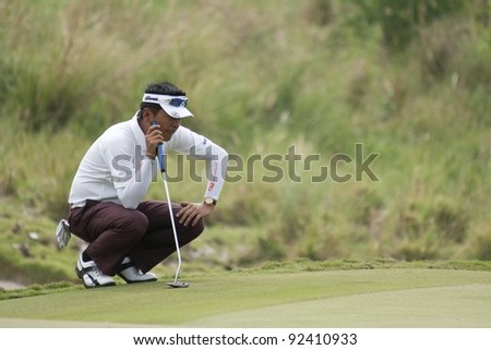 CHONBURI, THAILAND - DECEMBER 15: Lin Wen-Tang of Taiwan thinks of his next move during Day 1 of Thailand Golf Championship on December 15, 2011 at Amata Spring Country Club in Chonburi Thailand