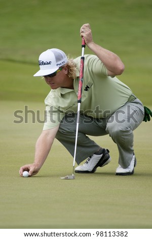 CHONBURI, THAILAND - DECEMBER 15: Charley Hoffman of USA prepares a ball to putt during Day 1 of Thailand Golf Championship on December 15, 2011 at Amata Spring Country Club in Chonburi, Thailand