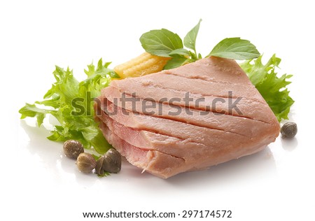 Piece of tuna fillet with fresh green lettuce, basil and mini corn