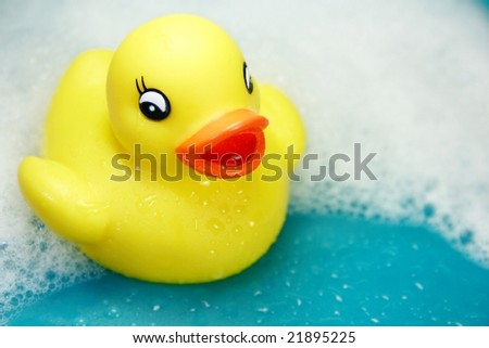 rubber ducky against soapy background