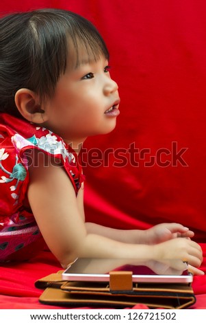 China girl in traditional Chinese red Tang suit greeting and play smartphone