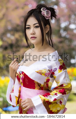 Asian sexy woman wearing traditional Japanese kimono and   Wild Himalayan Cherry Or Cherry blossom