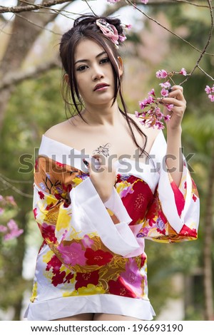 Asian sexy woman wearing traditional Japanese kimono and Wild Himalayan Cherry Or Cherry blossom