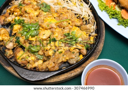 Thai food, fried mussel pancake in hot pan or Oysters on the hot pan