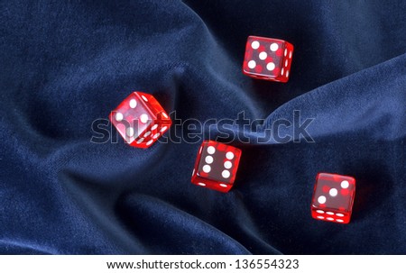 Red transparent playing bones on velvet background