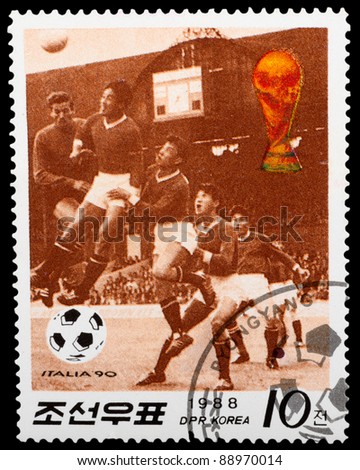 DPR KOREA - CIRCA 1988: a stamp printed by DPR KOREA shows football players. World football cup in Italy, series, circa 1988