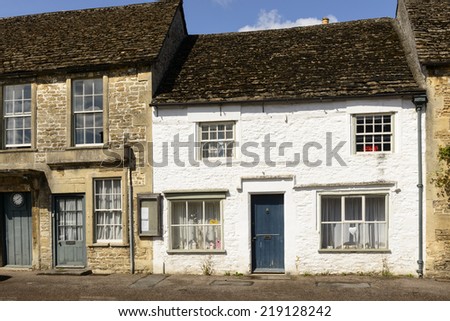 white painted stone cottage, Lacock medieval stone cottage painted in white, prospecting on a street in historic touristic village of  Wiltshire
