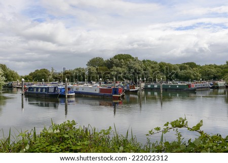 narrow boats at Thames and Kennet Marina, Reading view of river harbor for narrow boats on river Thames, shot under cloudy yet bright sky