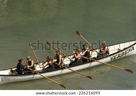 CLOVELLY, UNITED KINGDOM - AUGUST 16 a rowing boat team makes its way to competition ground during the Copilot Gigs Regatta rowing competition, shot on 2014 august 16, Clovelly, Devon, United Kingdom