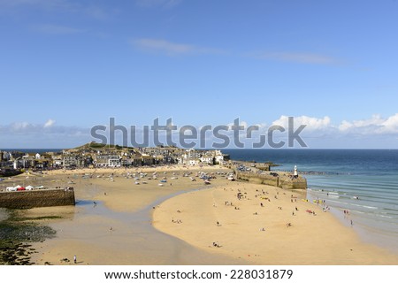 St. IVES, UNITED KINGDOM - AUGUST 17 people walk in the dry harbor at week end at low tide time, shot on 2014 august 17, St. Ives , Cornwall, United Kingdom