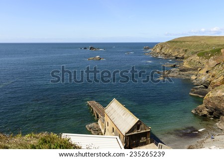 Polpeor bay Life Boat station at Lizard point, Cornwall,
sea landscape of coastline with cliffs and rocks of touristic location in Cornwall with the old lifeboat building