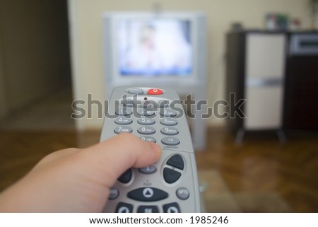 TV Remote control. Change the channel concept. TV Remote control - Hand and tv remote control.