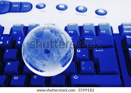 Glass world globe on keyboard. Business concept. World globe