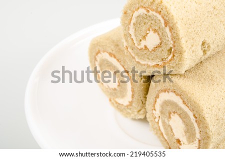 Image of coffee cream roll cake on white dish