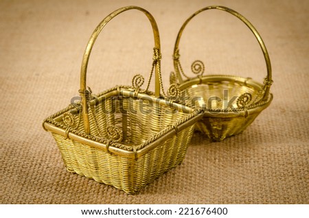 Image of mini gold basket on brown sack