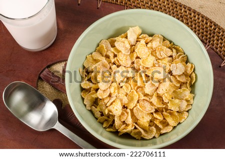 Image of breakfast cereal in green ceramic bowl on brown sack