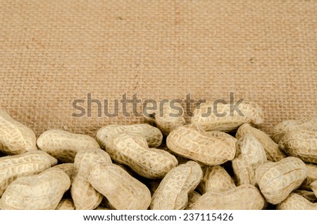 Image of roasted peanuts on brown sack background