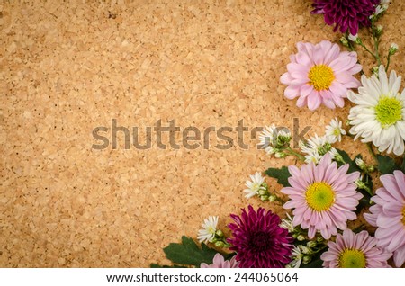 Image of flowers on brown cork background