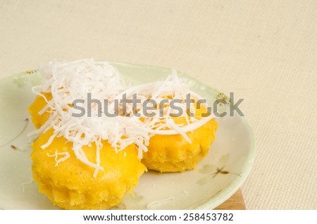 Thai dessert with coconut topping on sack fabric background