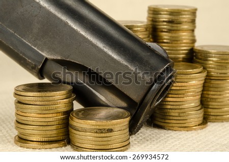 Gun and money on brown sack background