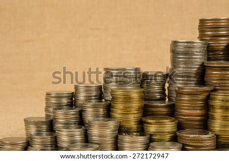 Stack of coins on brown sack background