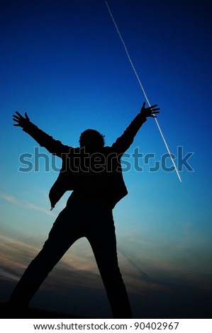 silhouette of a woman raising her arms out to the sky