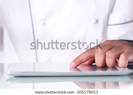 Chef is using a digital tablet