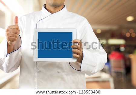 Chef showing a digital tablet in the restaurant